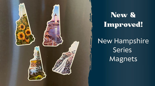 An image of four New Hampshire shaped landscape paintings on a stainless steel surface. Text at right reads, "New & Improved! New Hampshire Series Magnets"