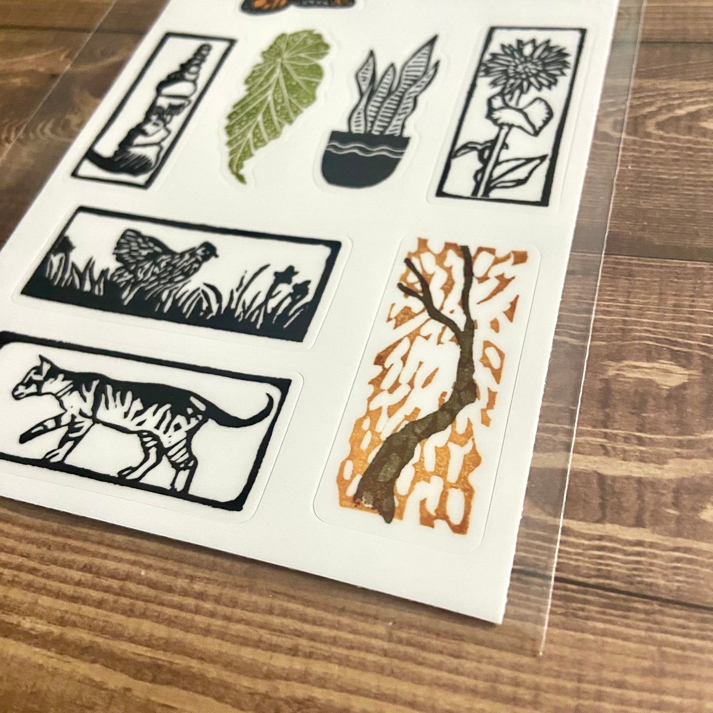 A close-up, angled view of my eraser art sticker sheet "ALLnatural". At this angle, you can see the cut line around each vinyl sticker.
