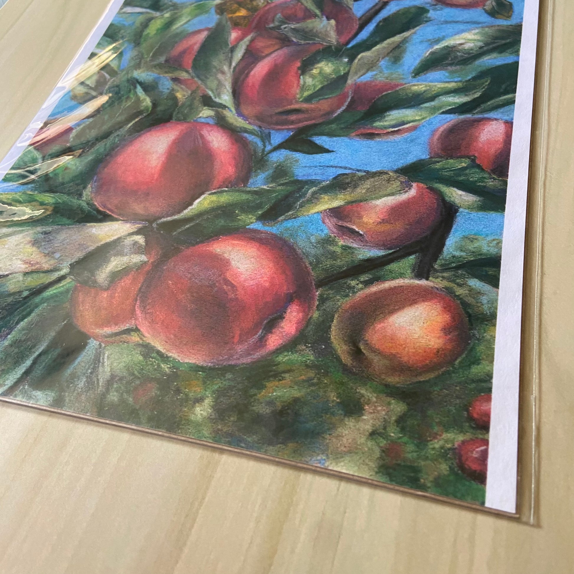 A detail view of the bottom of the art print. The soft pastel medium has a chalky texture, which shows well in the print copy. The light on the red fruits and green leaves shows their shape in a naturalistic way.