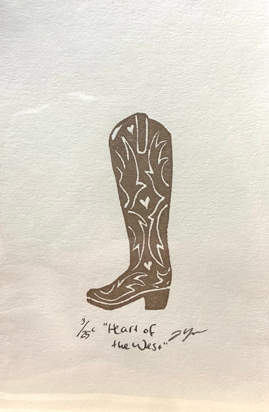 A brown and white relief print of a cowgirl boot, made by hand using a carved eraser. The print is numbered, signed, and titled "Heart of the West".