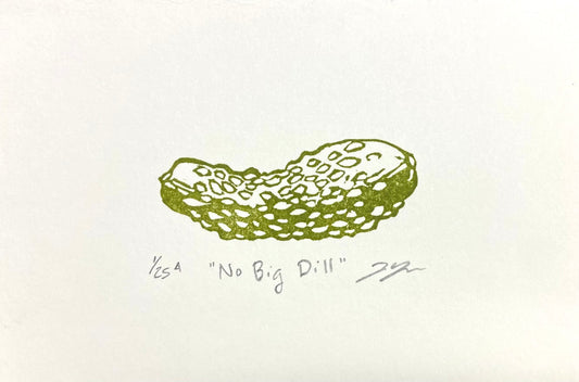 An olive green relief print of a small snacking pickle, titled No Big Dill. The print is handmade with a carved eraser and comes titled, numbered, and signed by hand.