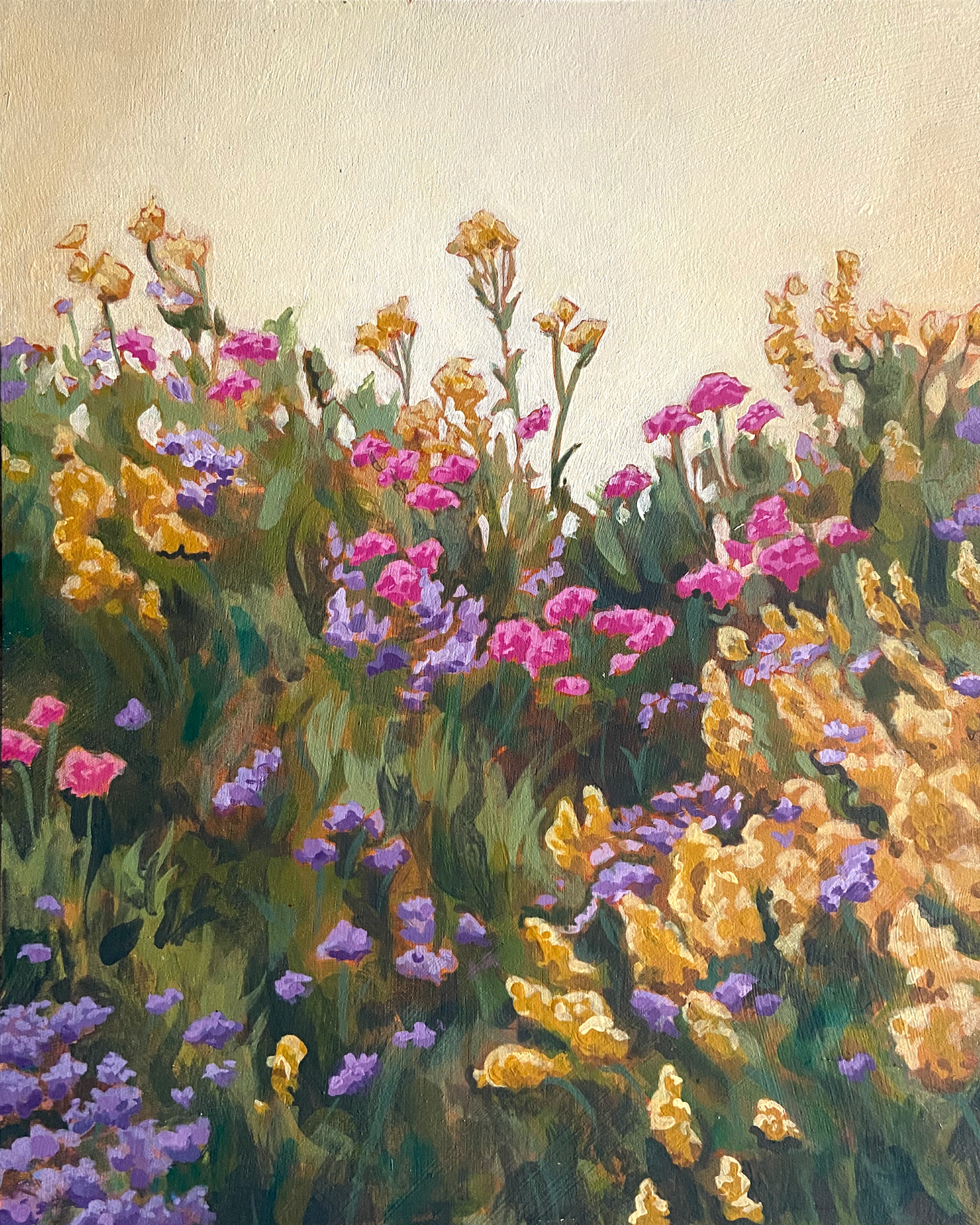 A painting of gold, pink and purple flowers in a lush green field in front of a bright golden sky.