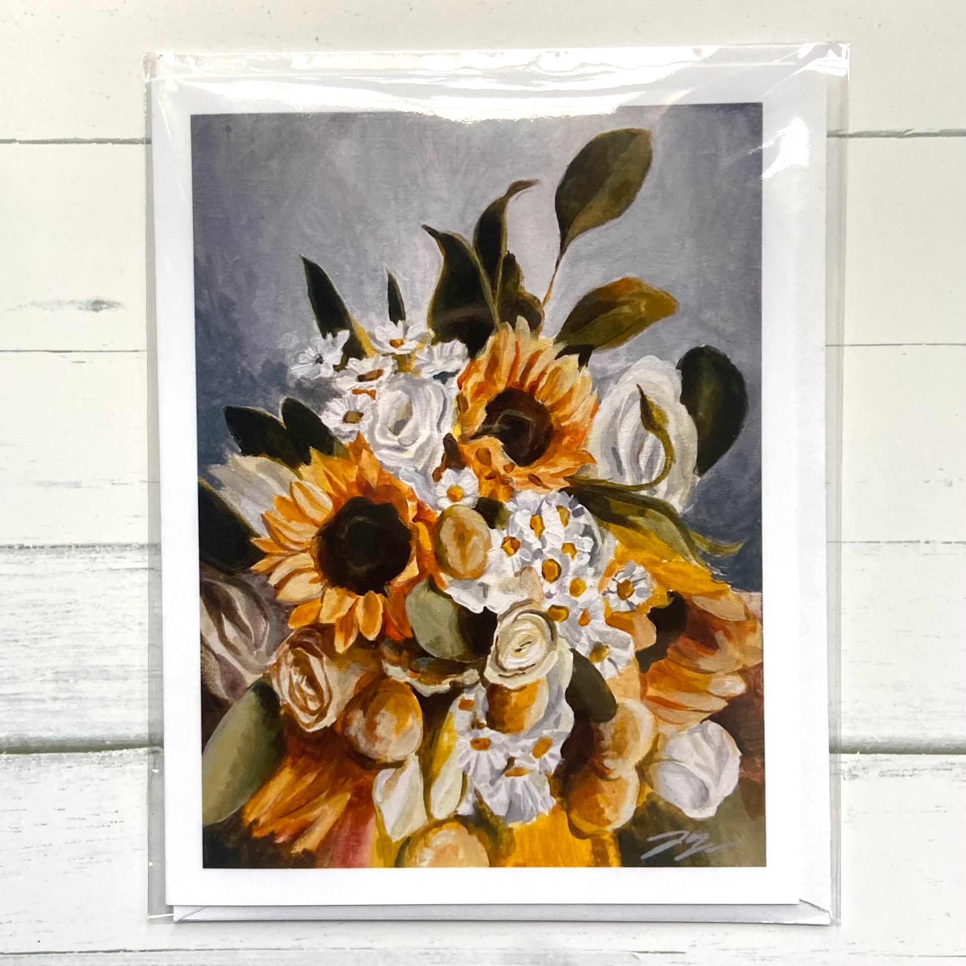 A folded white greeting card of my painting, Green Gold, depicting a bouquet of sunflowers, daisies, and white roses.
