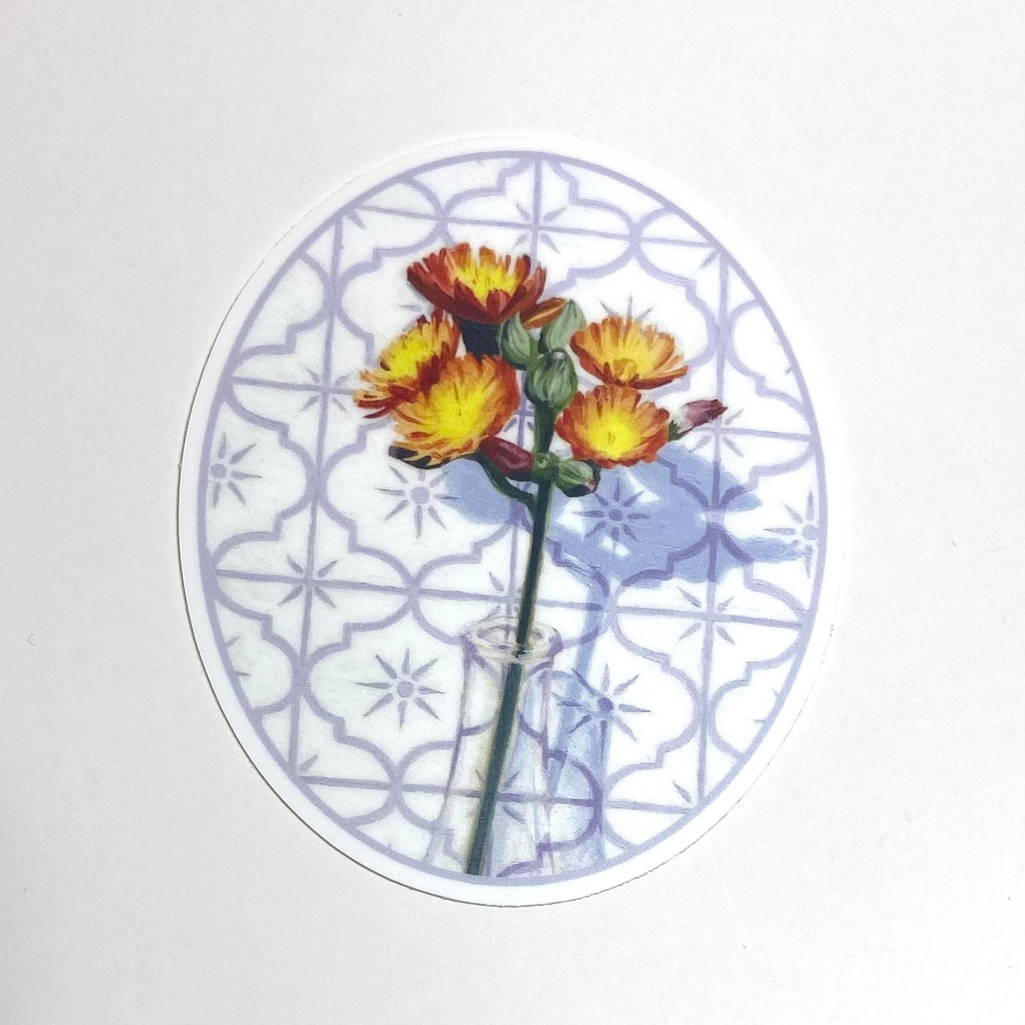 An oval-shaped sticker depicting a painted hawkweed flower in a glass before a tile background.