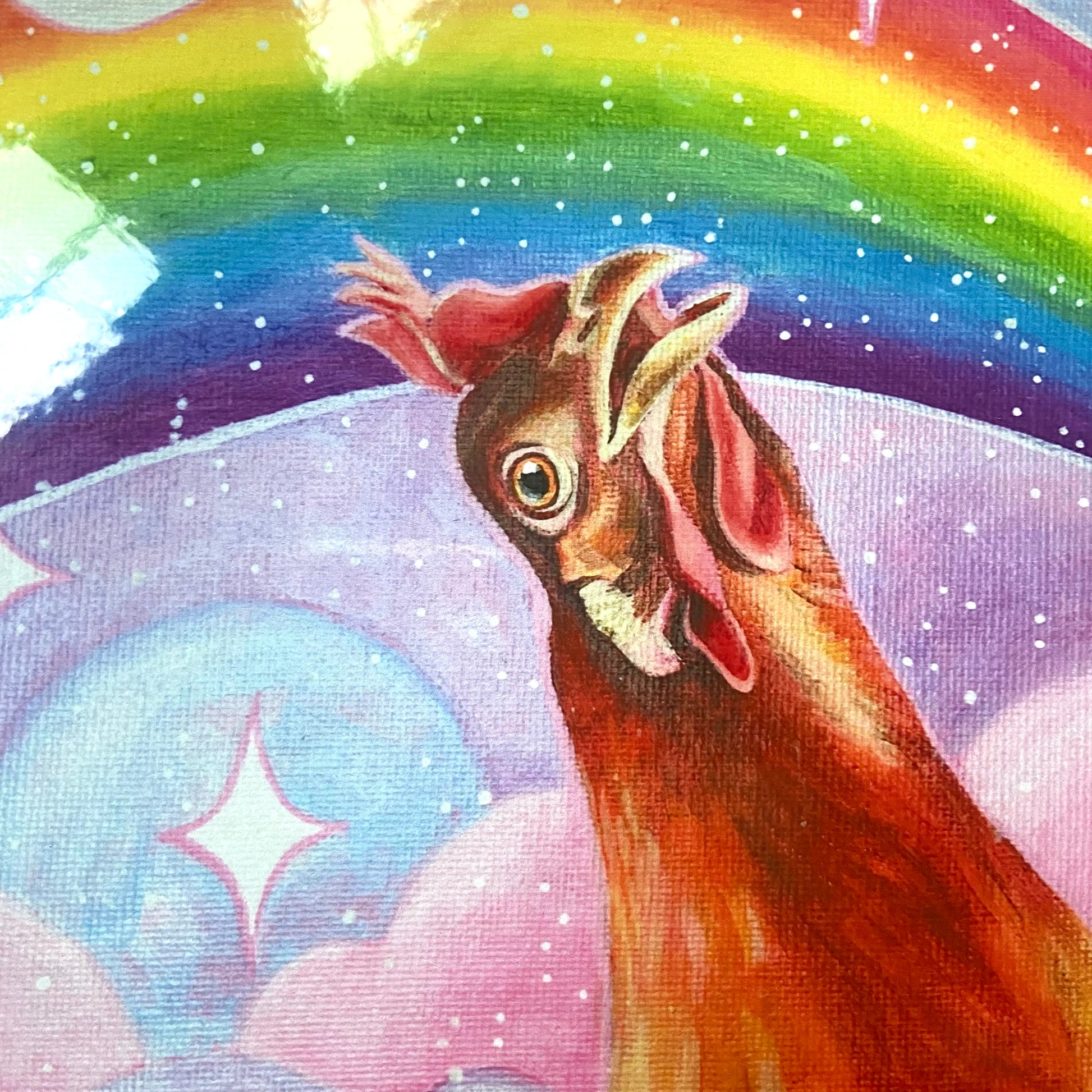 "Nostalgia Hen" print by artist Jackie Hanson, shown packaged as a print in a cropped-in, detail view. The print shows an orange chicken looking in awe at a vibrant, glittery rainbow in a pink and purple sky.
