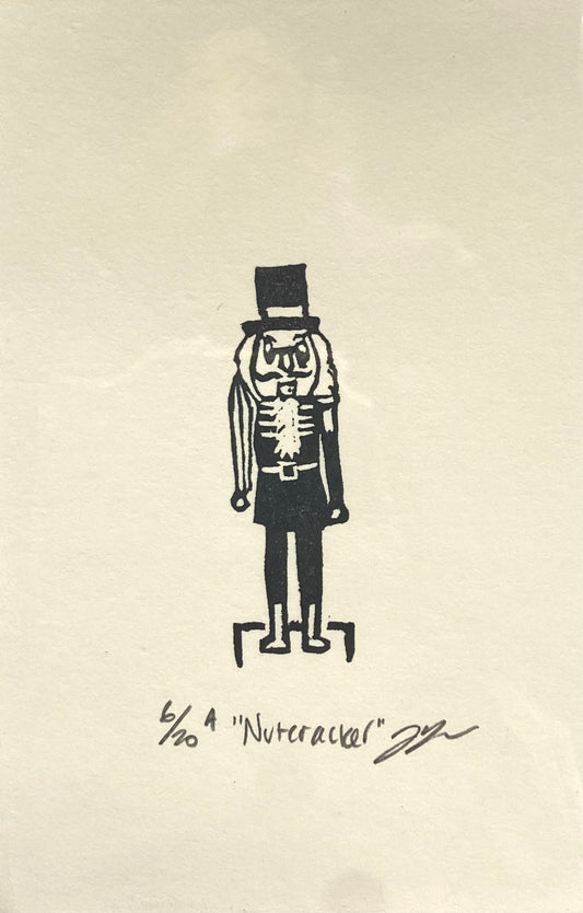 A small black-and-white print of a traditional Christmas nutcracker.  The print is made by hand using a carved eraser and is numbered, titled and signed.