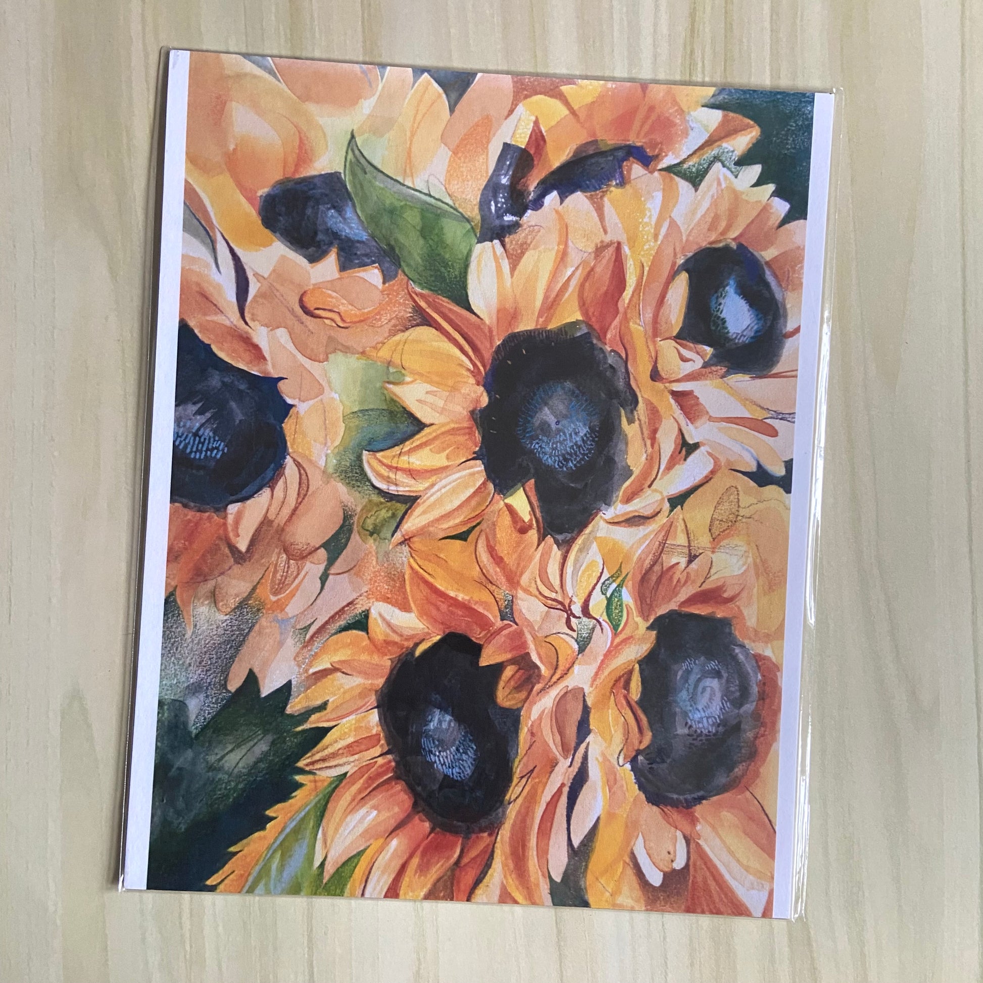 A print copy of a painting depicting several sunflowers, with joyful watercolor brush marks and pencil details.