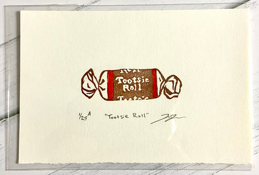 A two-color relief print of a Tootsie Roll candy. The prints are made by hand from a carved eraser and are numbered, titled and signed.
