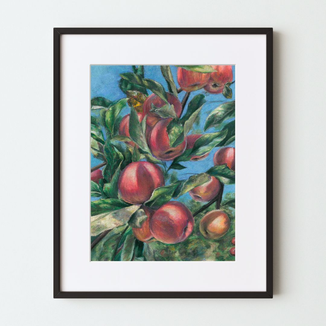 A mockup of a colorful art print in a black frame with a white mat. The painting, made with soft pastels, shows several ripe apples on a tree branch in the sun, in front of a bright blue sky. The light on the fruit and leaves is very realistic.