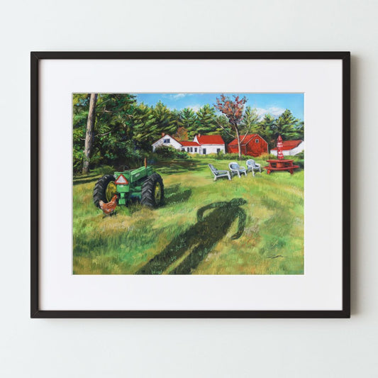 A mockup of a landscape art print in a black frame with a white mat. The artwork shows a farmhouse with a barn and tractor on a green grassy field. There is a long shadow of a man walking coming from the bottom edge of the piece.