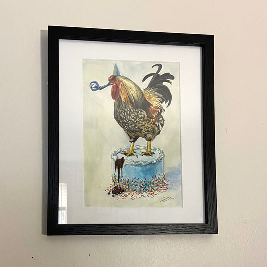 A painting of a colorful rooster standing on a ruined birthday cake. He wears a blue party hat and has a blue noisemaker in his beak. The painting is in a black frame with a white mat.