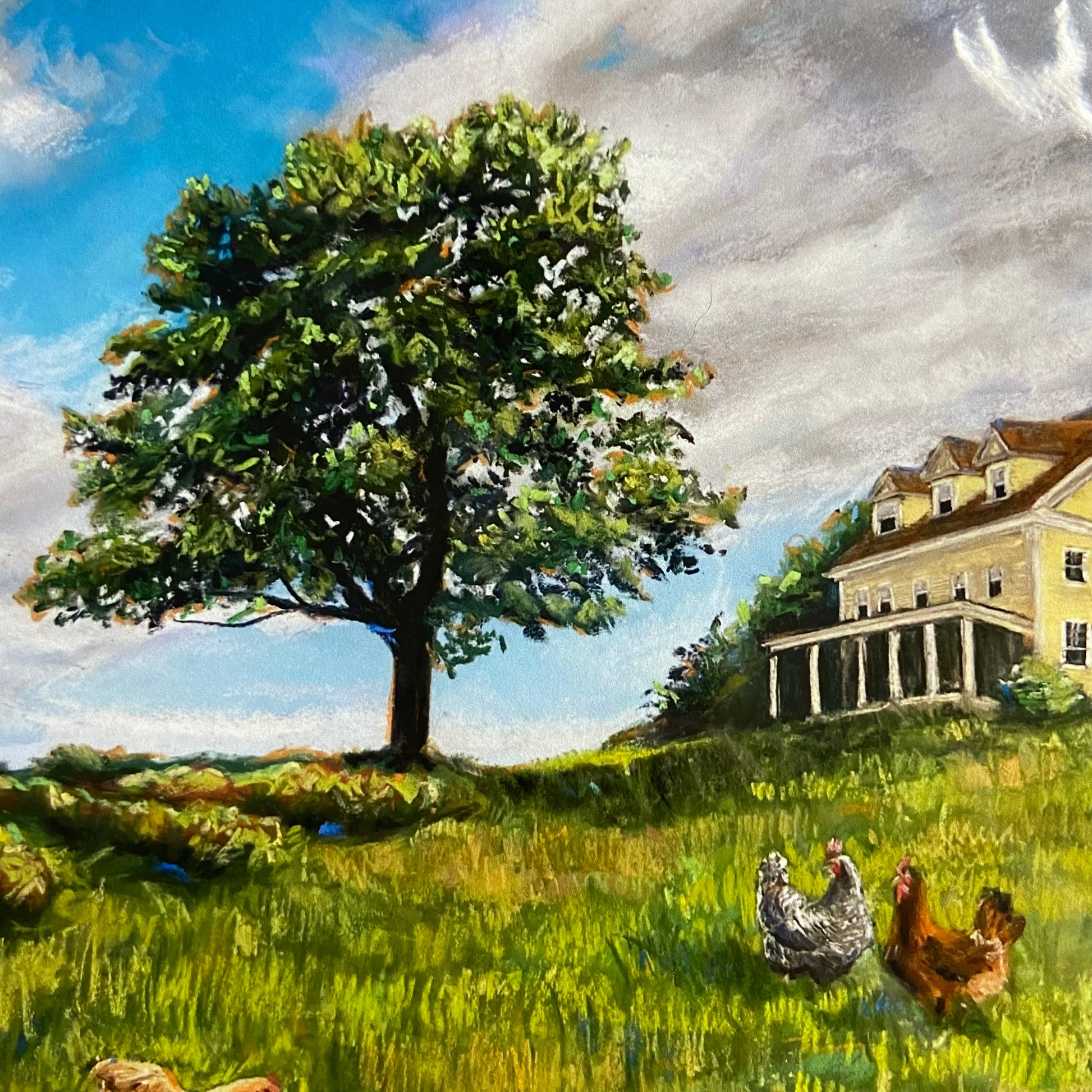 A close-up of the wall art print. Details of the lone tree are in focus, along with the front of the yellow house and two of the hens. The texture of the painting really shows here, from the smoothness of the sky to the grainy layers in the lawn.