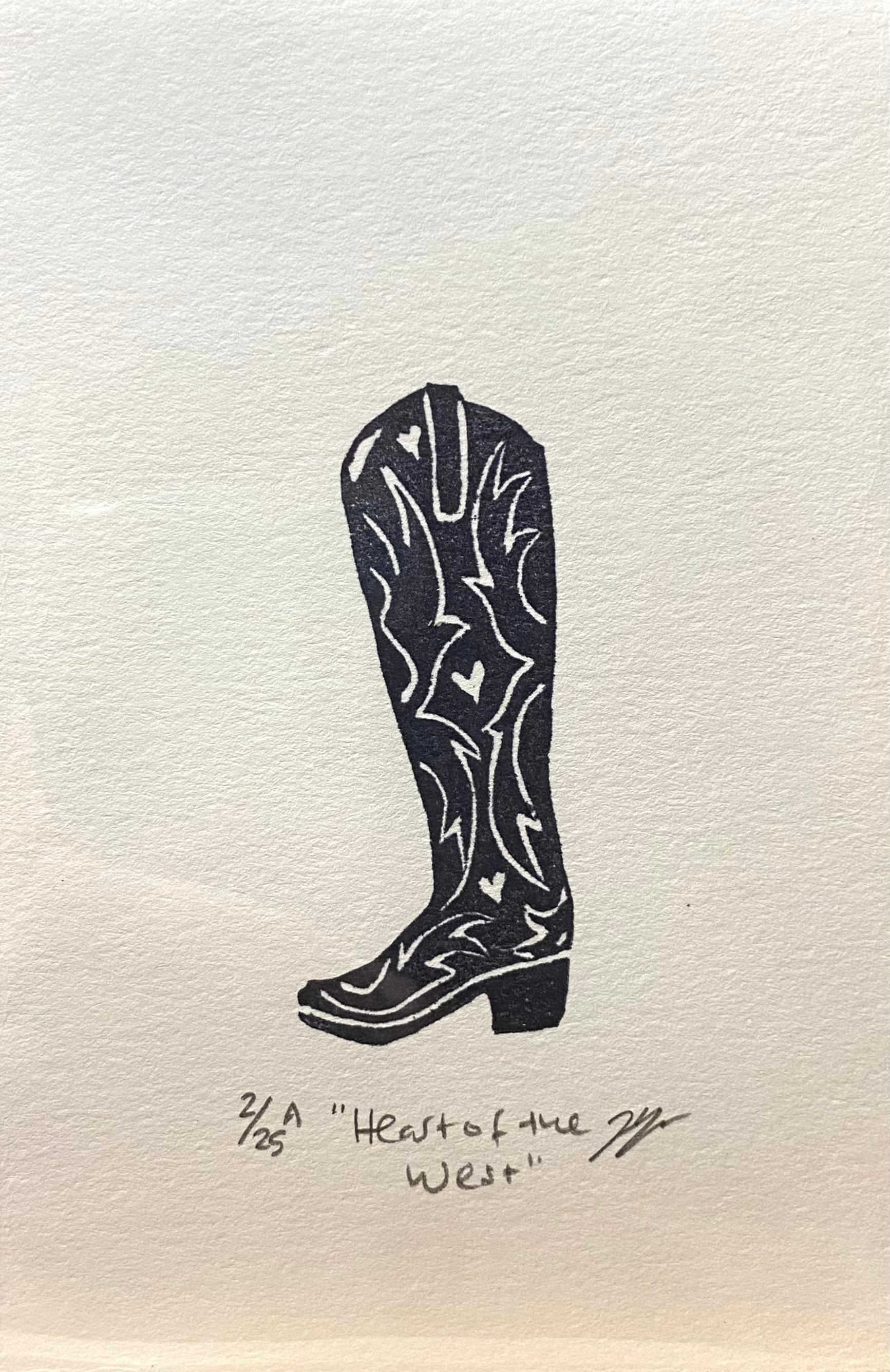 A black and white relief print of a cowgirl boot, made by hand using a carved eraser. The print is numbered, signed, and titled "Heart of the West". 