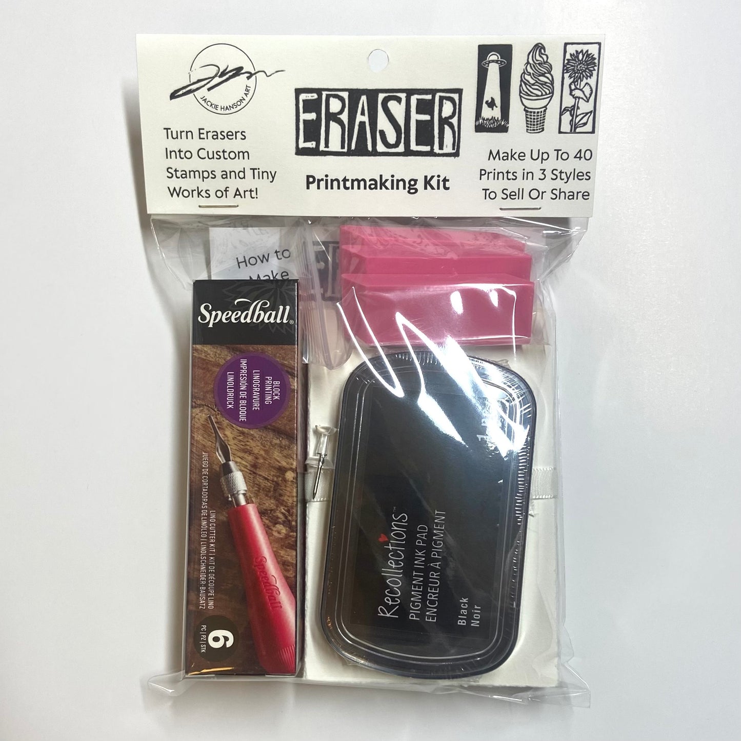An eraser printmaking kit on a white background, which includes a linocut carving tool, black ink pad, three erasers, and more on a white background.