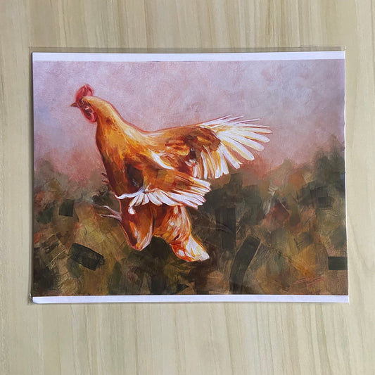 An art print of an orange chicken in flight over an abstract background. The print has thin white borders at top and bottom and is sealed in a clear plastic sleeve.