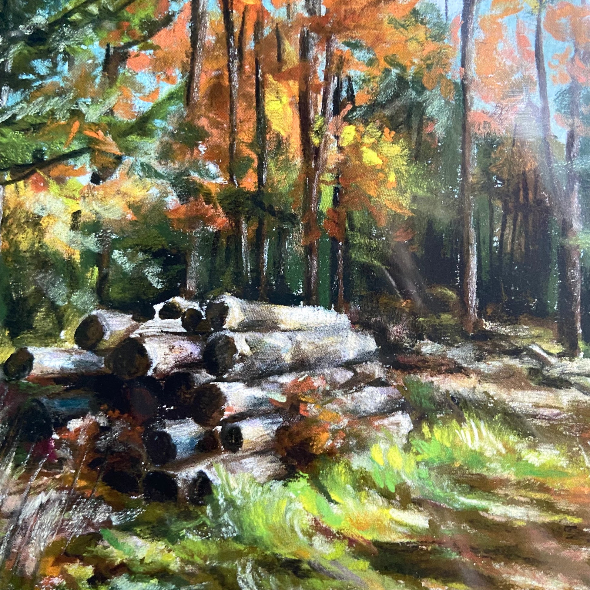 A close-up look at the print's stack of cut wood in the foreground. The soft pastels' texture is obvious, and the vibrant colors used can be seen in the grass and foliage. The print quality is excellent, appearing very close to the real thing.