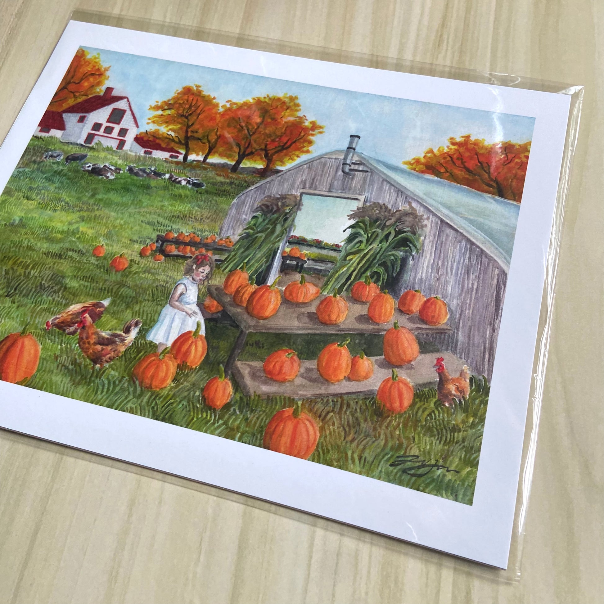 A closer look at the watercolor print. The illustrative grassy texture and vibrant colors are beautiful. the idyllic fall scene, whimsical style and young girl figure make this painting seem from a picture book.