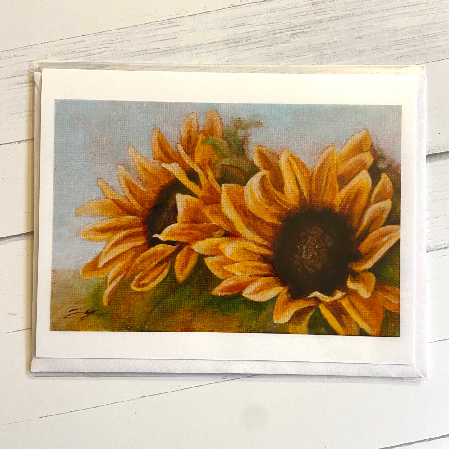 A landscape-style folded white greeting card featuring my painting "Looking Up", with two blooming sunflowers. 