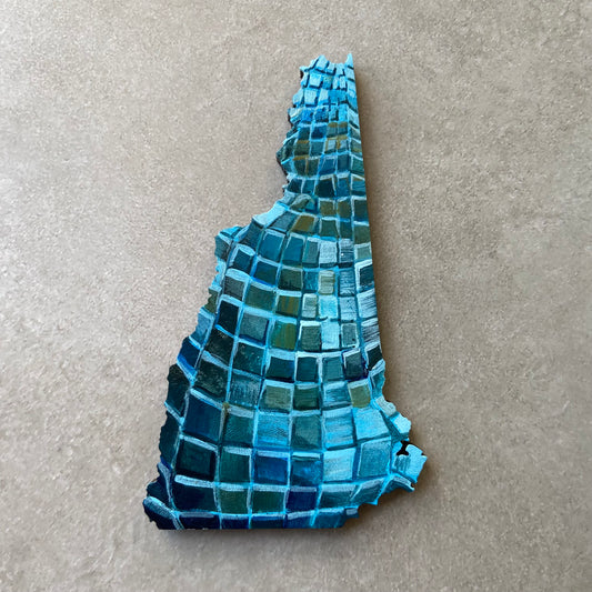 A New Hampshire- shaped painting on wood, painted with the pattern of a blue disco ball. 