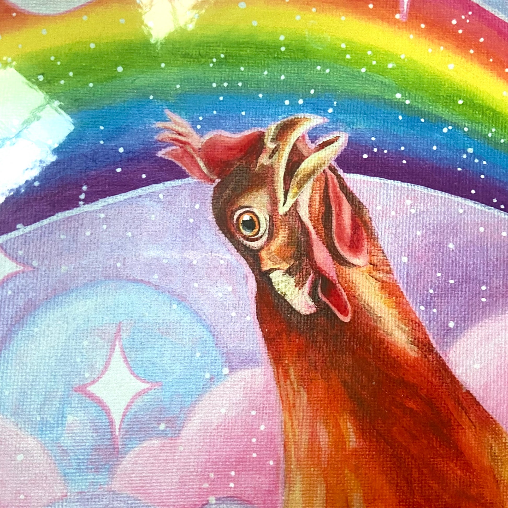 "Nostalgia Hen" print by artist Jackie Hanson, shown packaged as a print in a cropped-in, detail view. The print shows an orange chicken looking in awe at a vibrant, glittery rainbow in a pink and purple sky. 