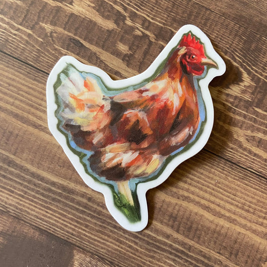 A sticker of an orange chicken viewed from the side, resting on a wooden surface. The hen is painted with gouache, with visible painterly brush strokes. Decal is die-cut to shape with a thin white border.