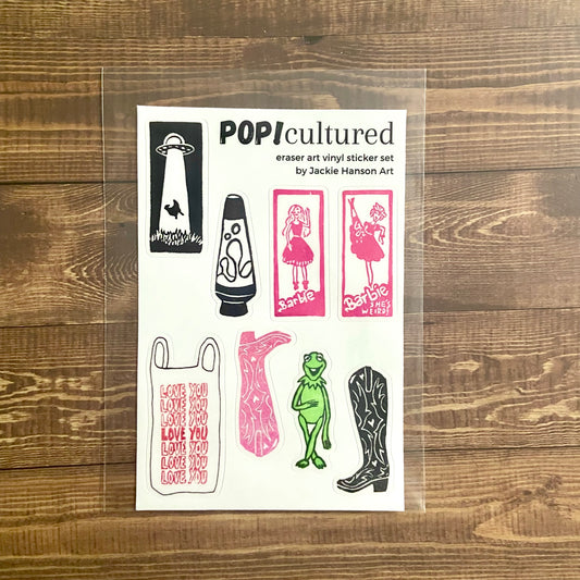 A 4x6 inch mainly white sticker sheet titled "POP!cultured". This set contains eight vinyl stickers of pop-culture-related eraser print designs I created. It is wrapped in a protective plastic sleeve.