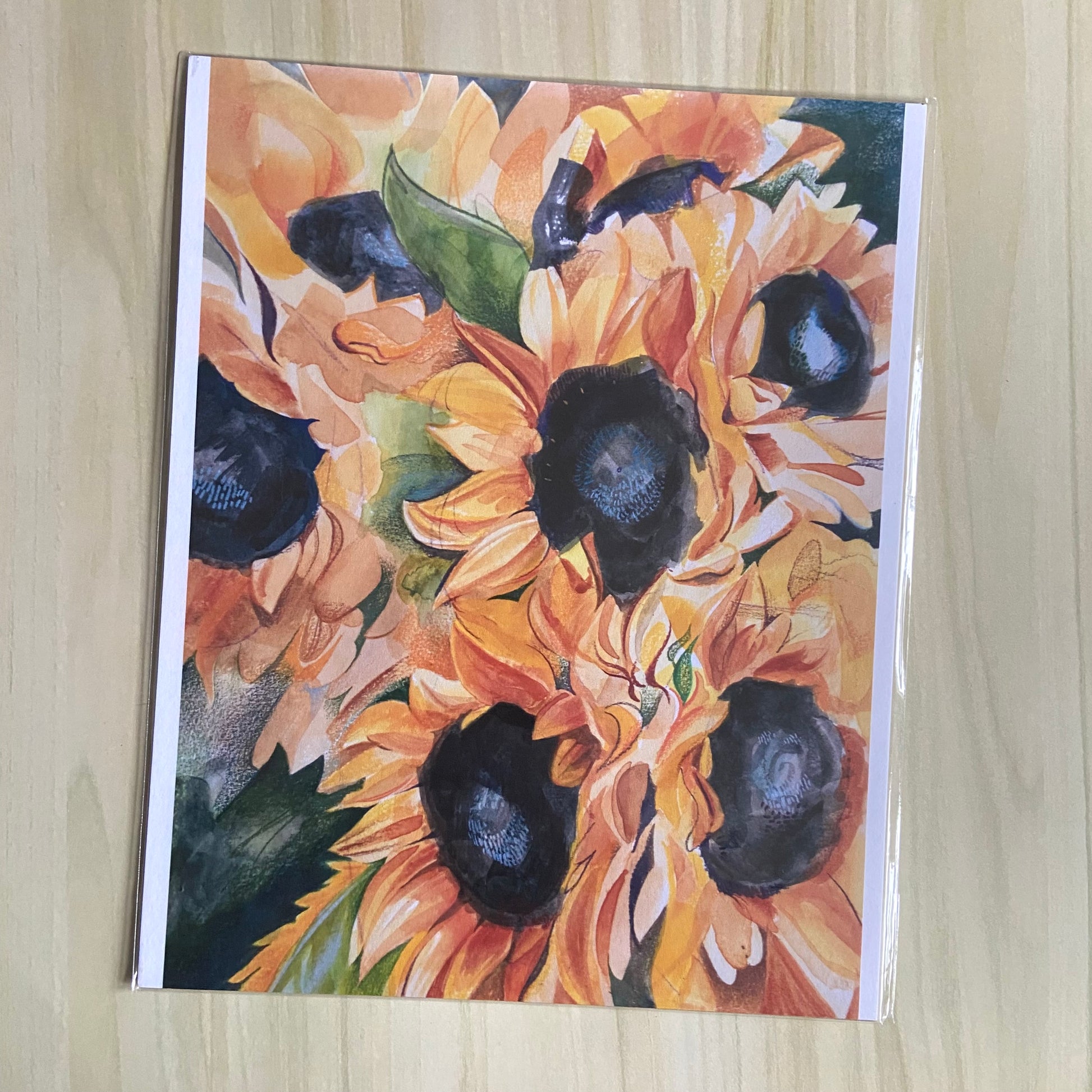 A print copy of a painting depicting several sunflowers, with joyful watercolor brush marks and pencil details. 