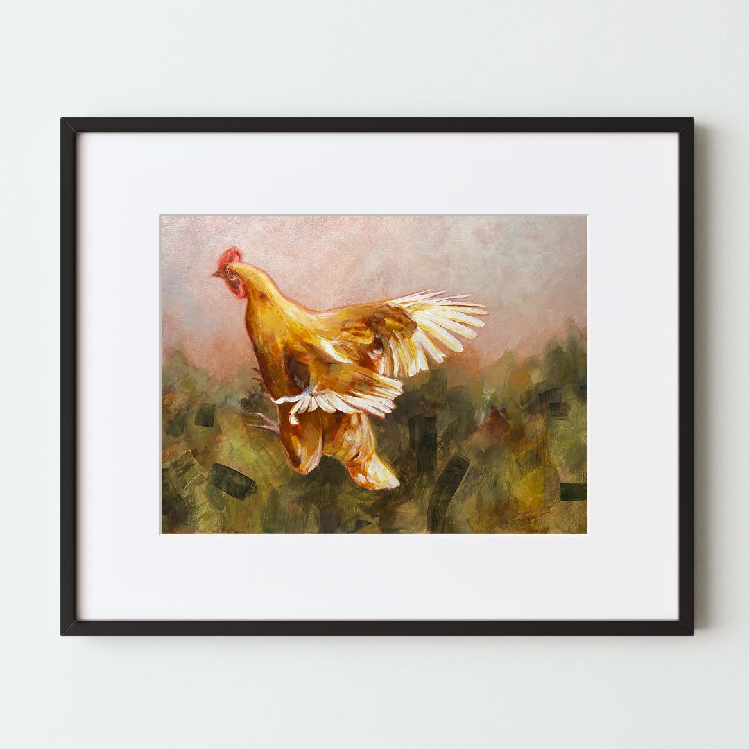 A mockup of an art print in a frame, depicting an orange chicken in flight over an abstract painterly background. 